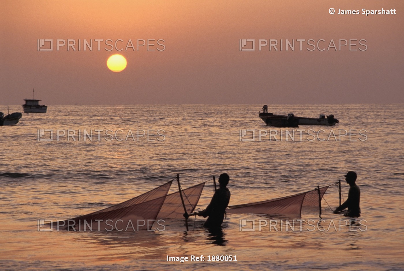 Fishermen Holding Nets In Sea At Sunset
