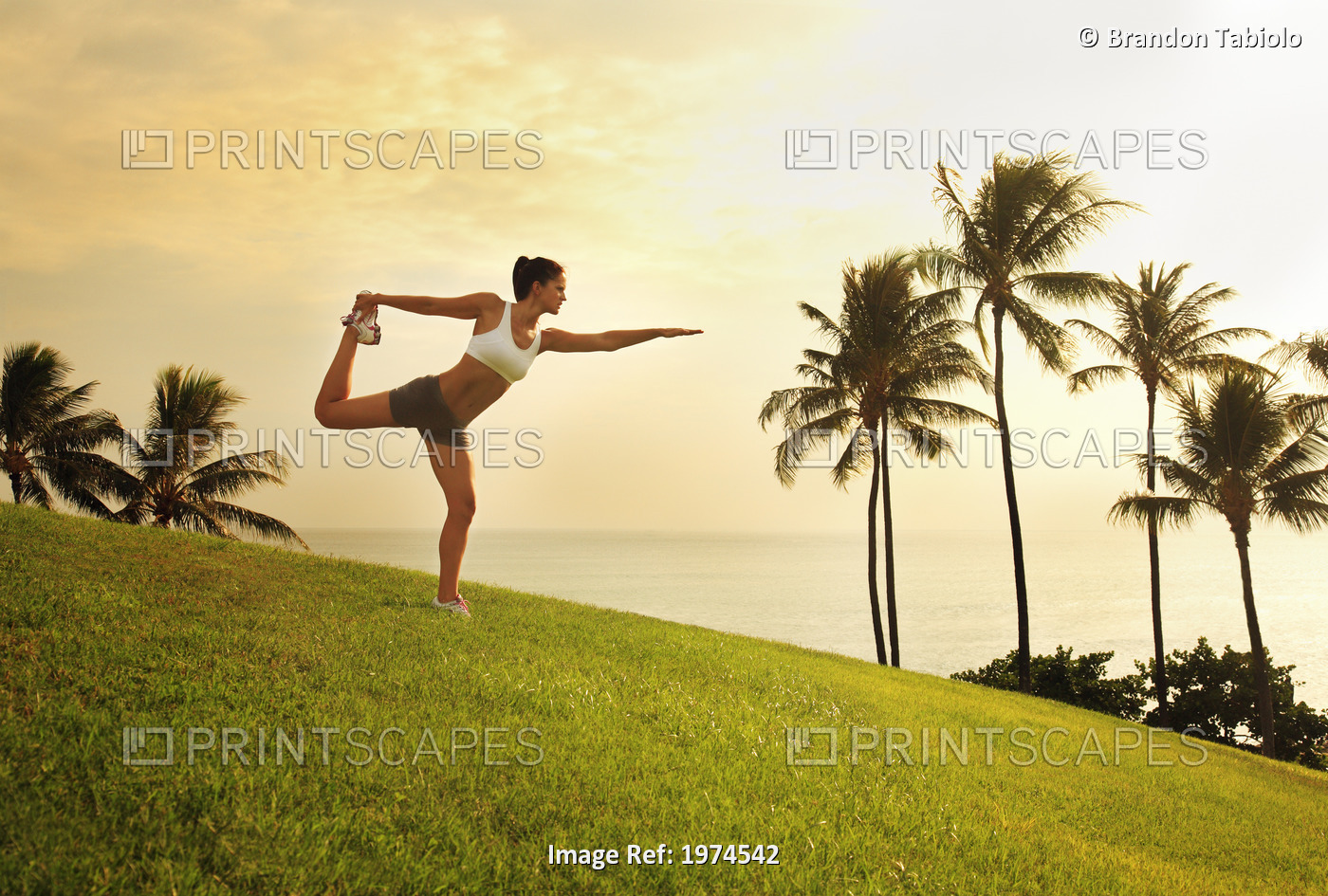 Hawaii, Oahu, Female Doing A Yoga Pose, Stretching On A Hill Overlooking Ocean, ...