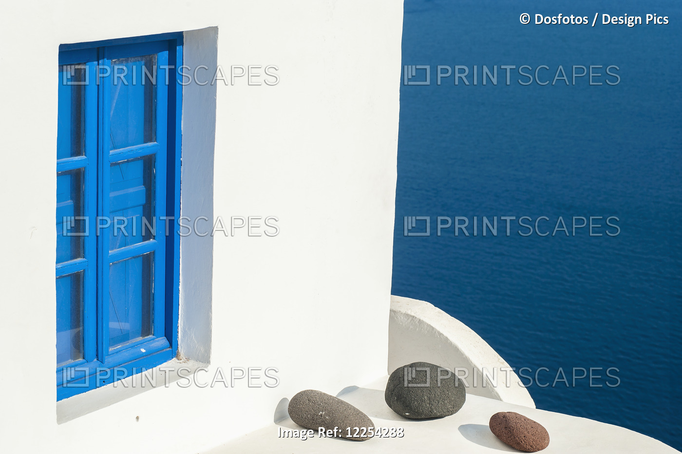 Whitewash Building With Blue Trimmed Window Along The Aegean Sea; Oia, ...
