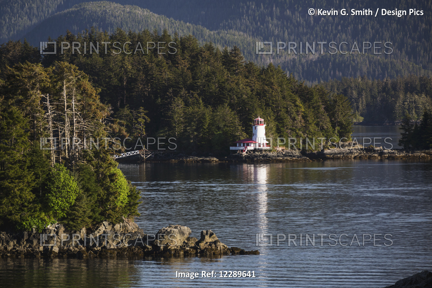Small Islands Populated By Sitka Spruce Trees, A Lighthouse In The Background; ...
