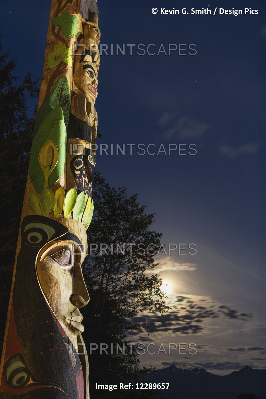 A Large Totem Pole Lit Up At Night In Sitka National Historic Park With The ...