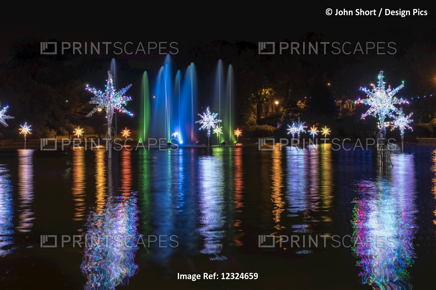 Illuminated Snowflakes And A Spraying Water Fountain Illuminated With Colourful ...