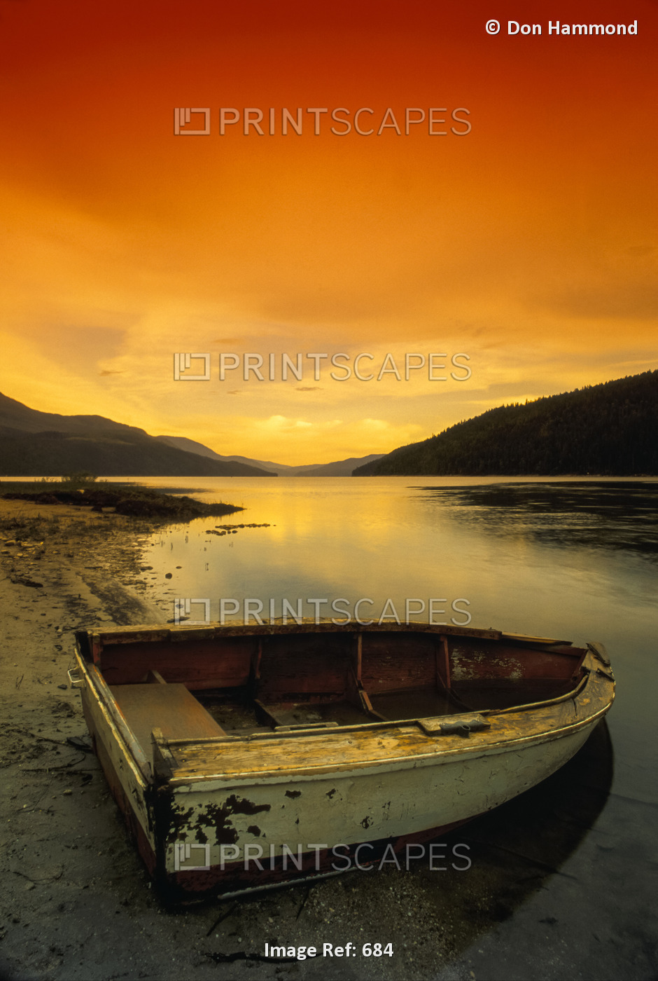 Old Rowboat At Water's Edge With Sunset Background