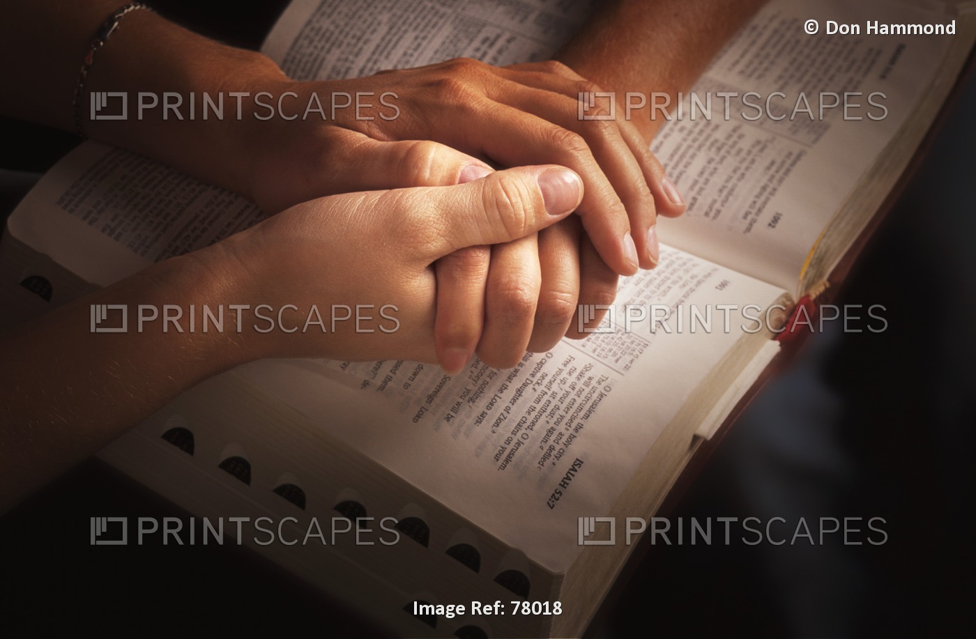 Holding Hands And Praying Over The Bible