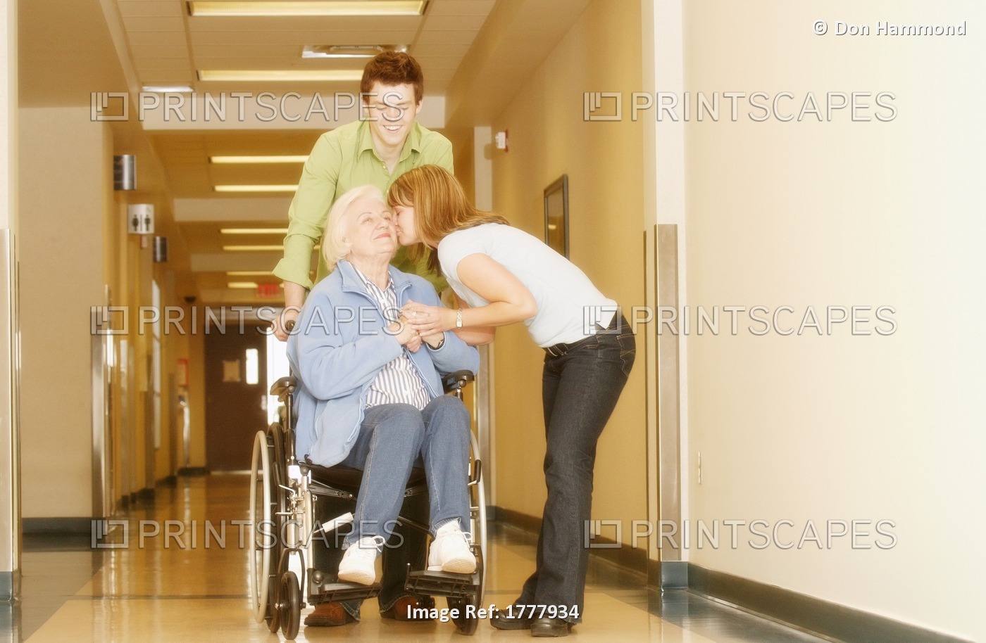 Two Young Adults Visiting A Senior Woman In The Hospital