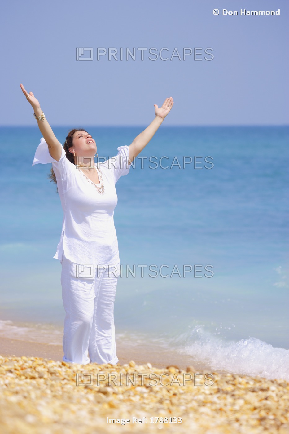 A Woman Raises Her Hands At The Beach