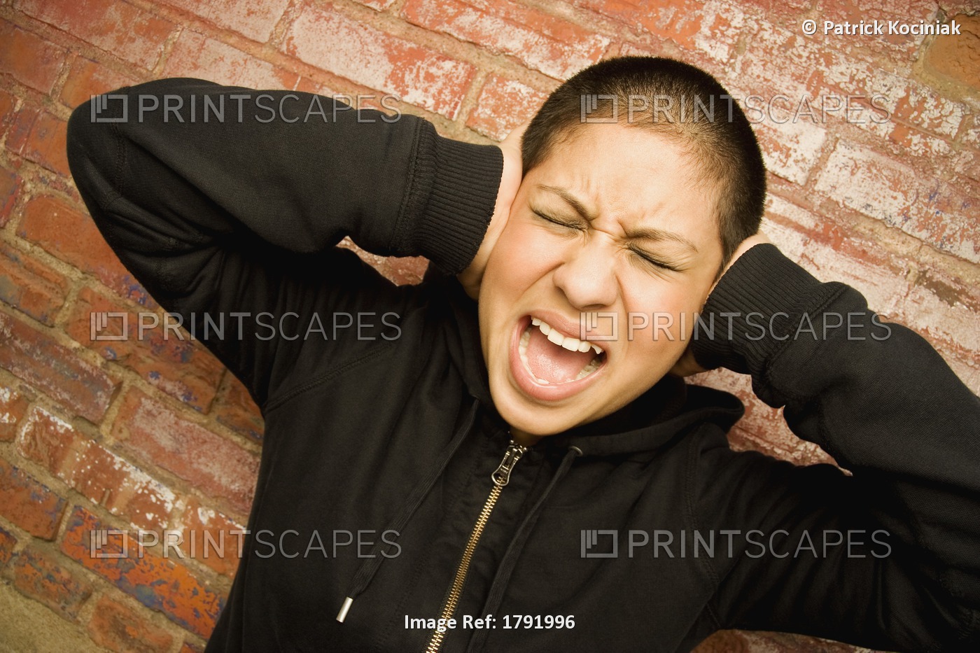 Young Woman Covering Ears And Screaming