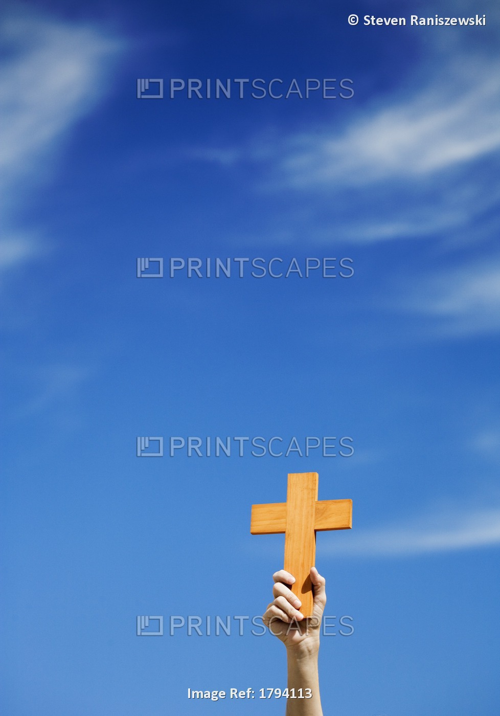 Person Holding Up A Cross