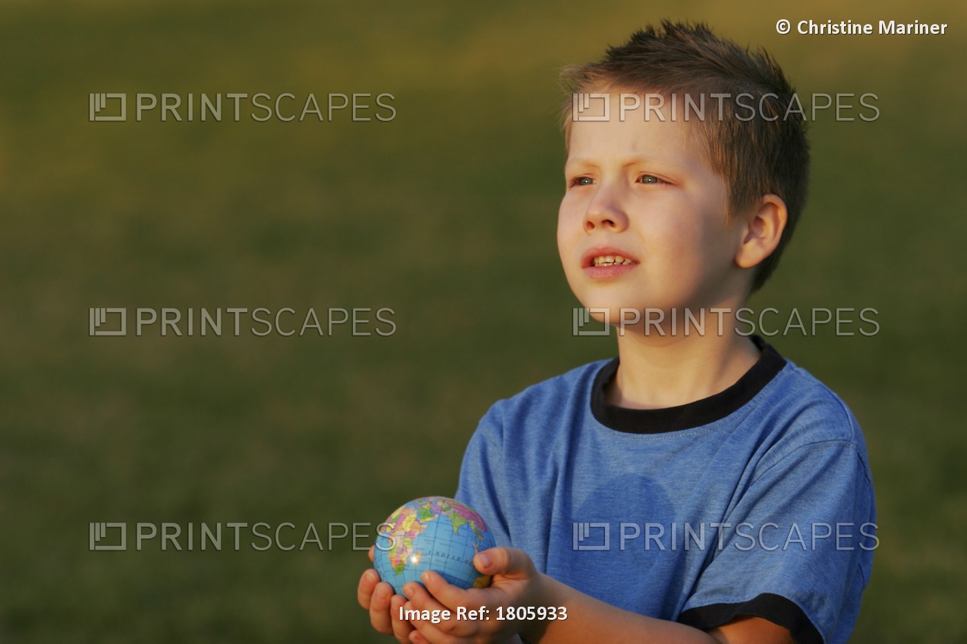 Boy Holding A Globe In His Hands