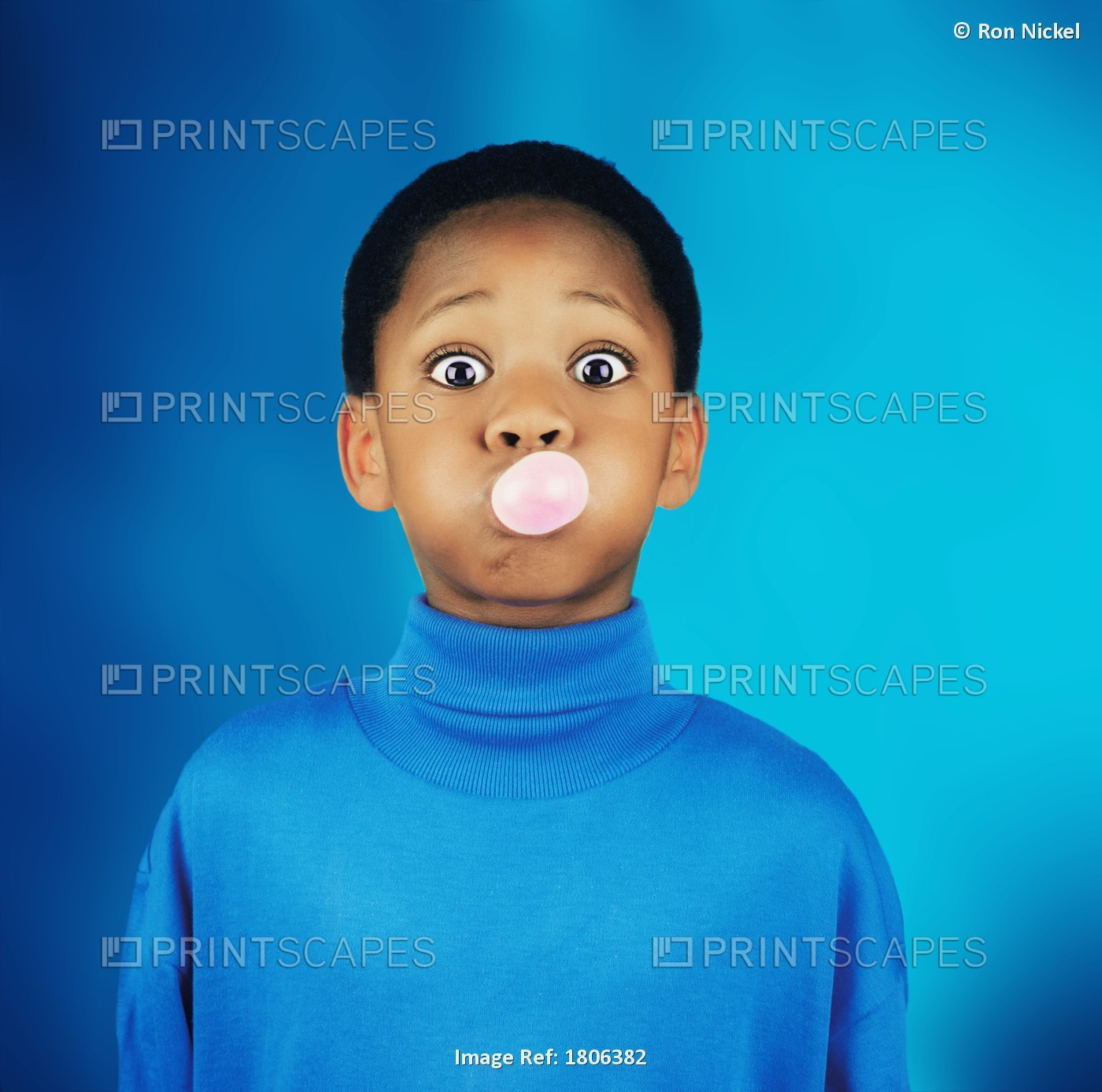 A Boy Blowing A Bubble