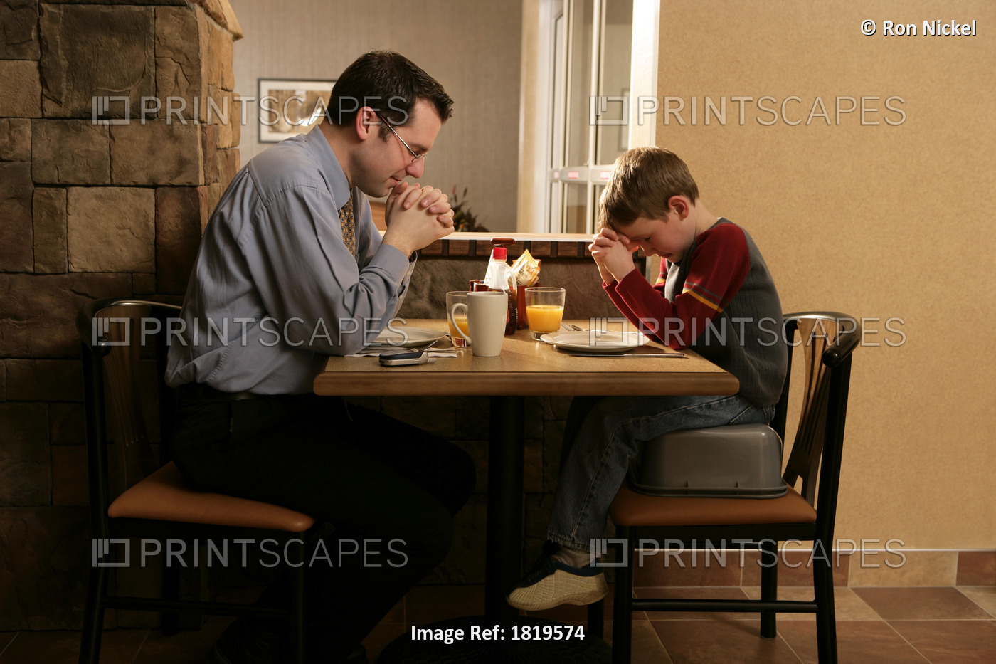 Father And Son Praying Before Meal