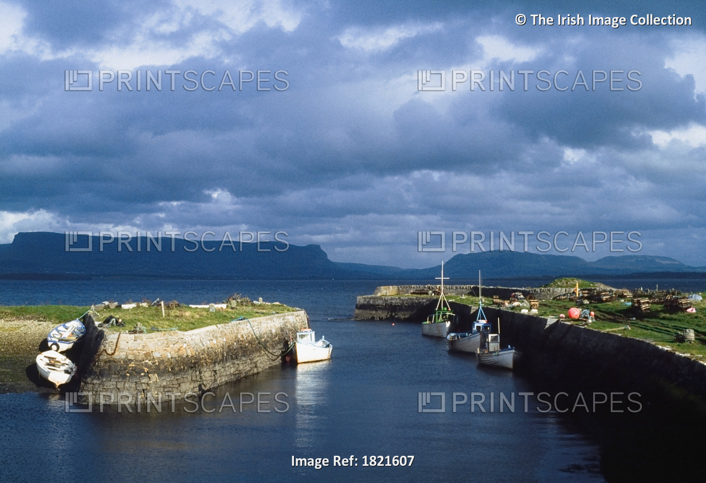 Ben Bulben, Co Sligo, Ireland; Docked Boats Across From A Rock Formation