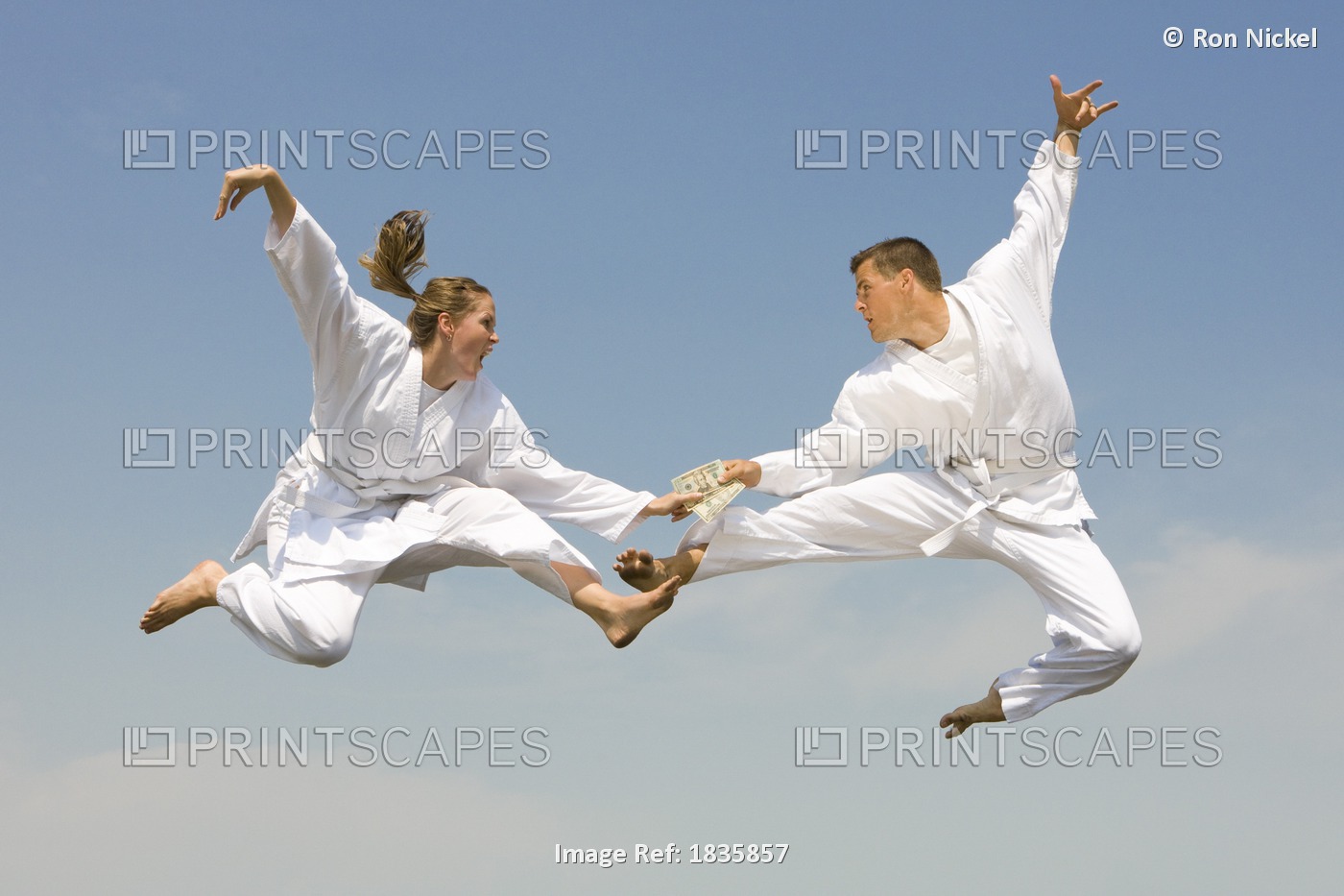 Young Woman Holding Cash Fighting Young Man As They Fly Through The Air