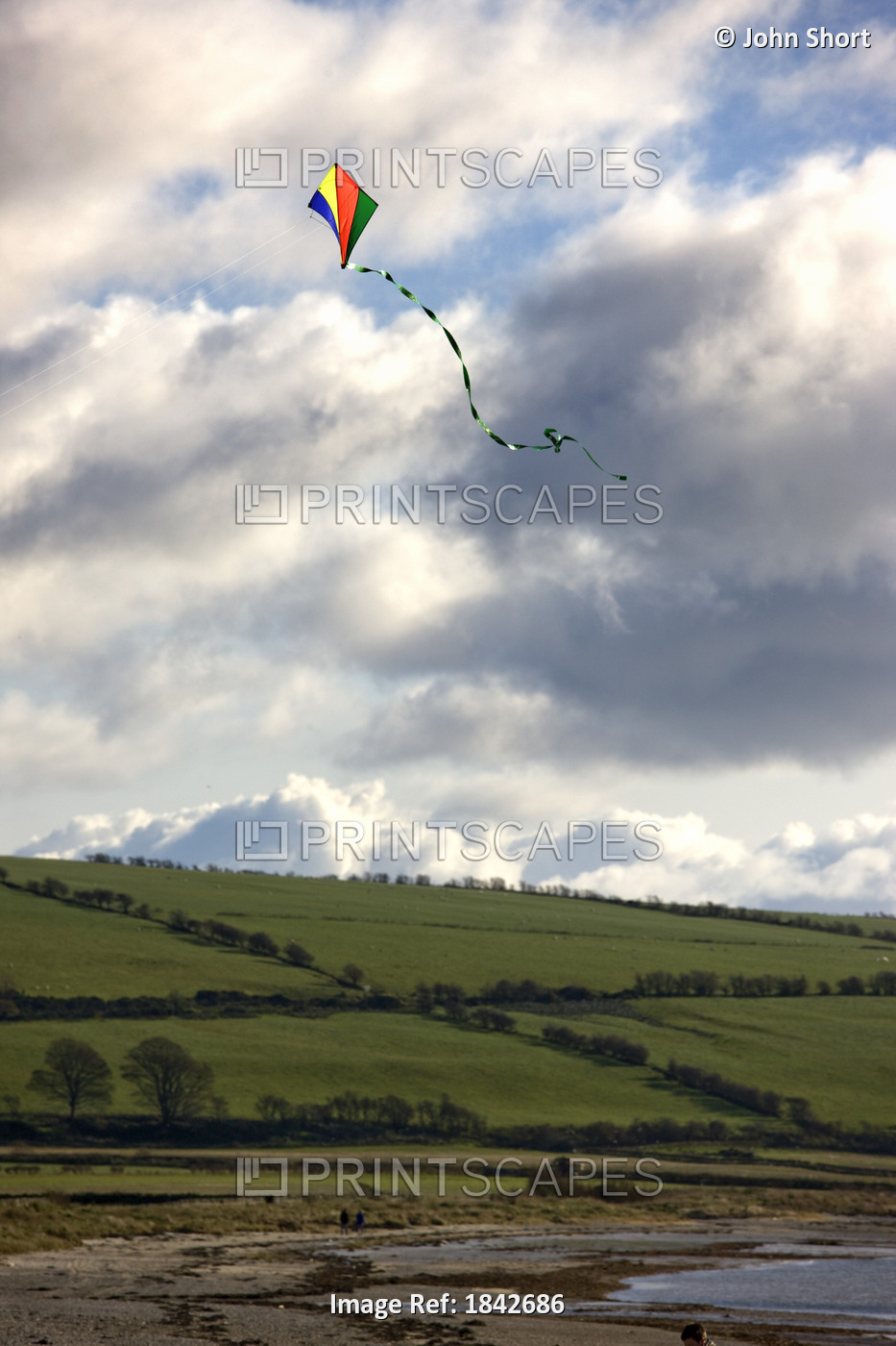 Isle Of Bute, Argyll And Bute, Scotland; Colorful Kite Against Cloudy Skies