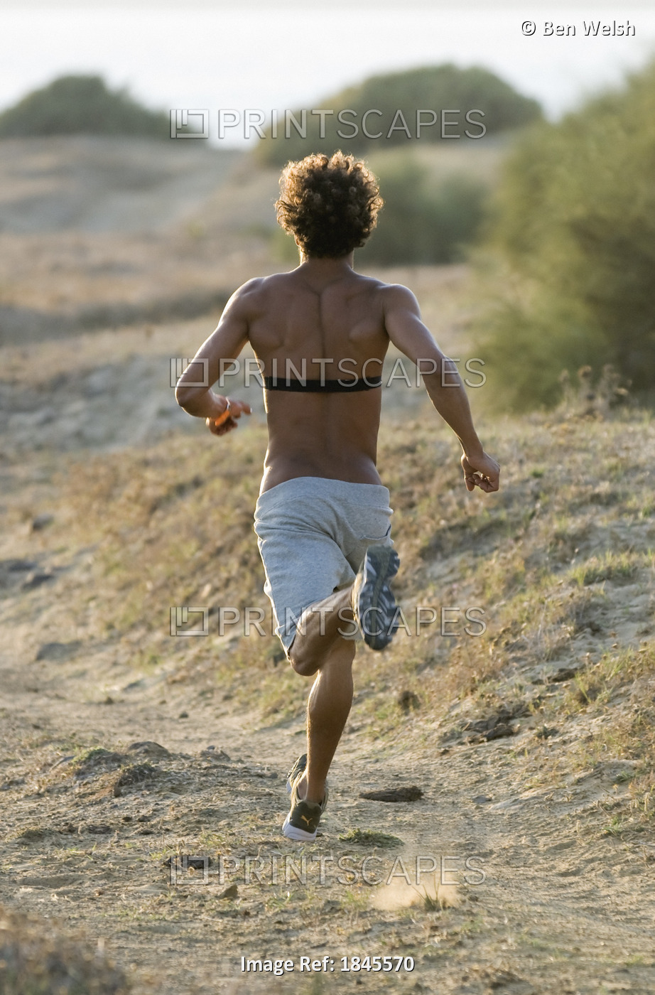 Young Man Running On Beach