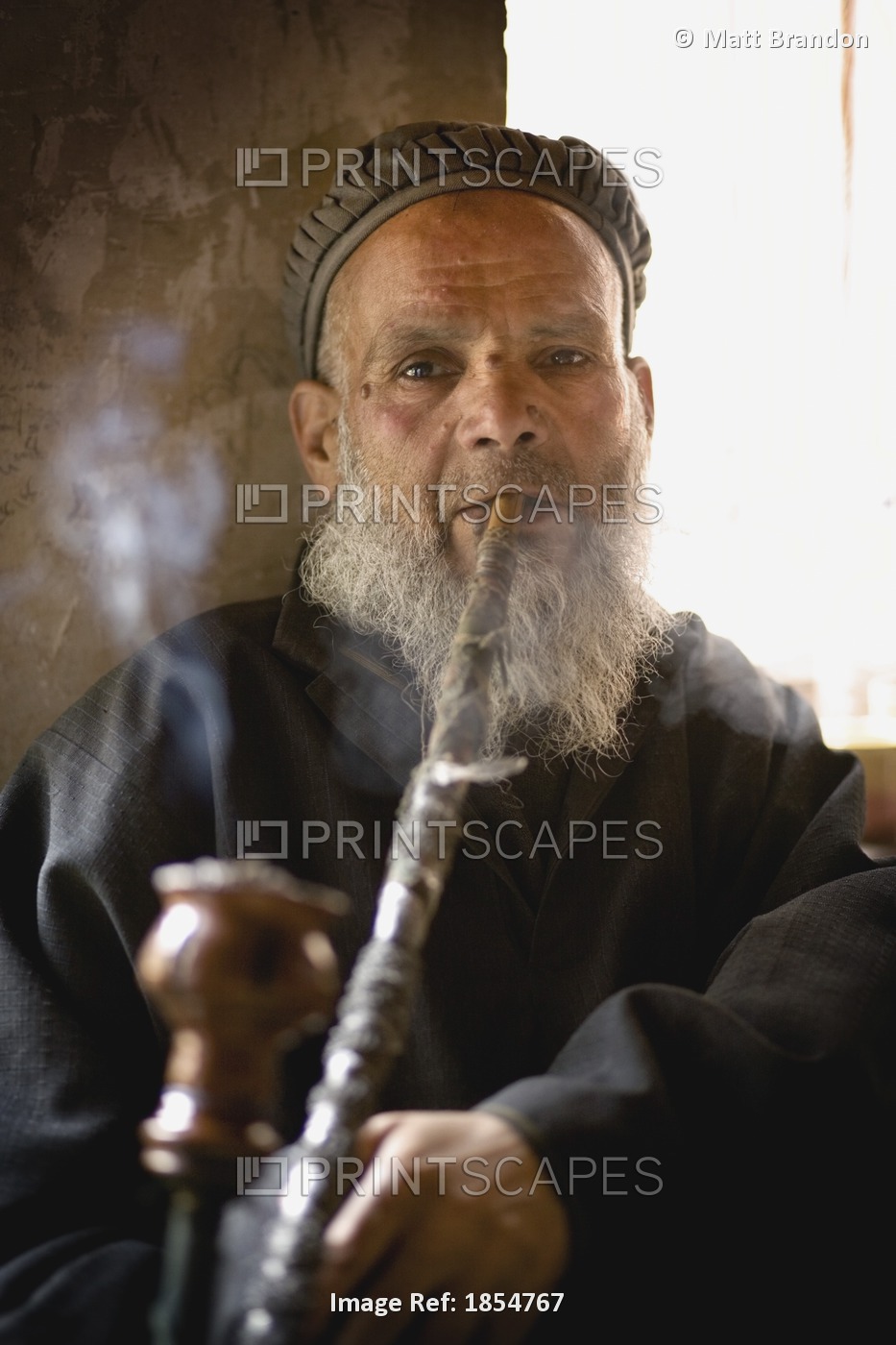 Man Smoking A Hookah