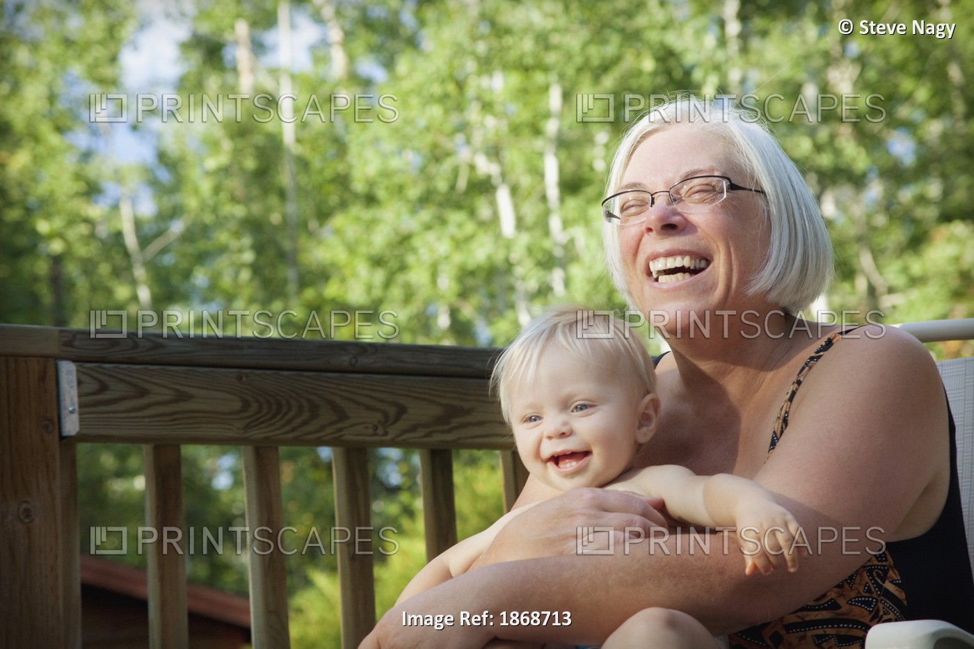 Grandmother Laughing With Infant Granddaughter