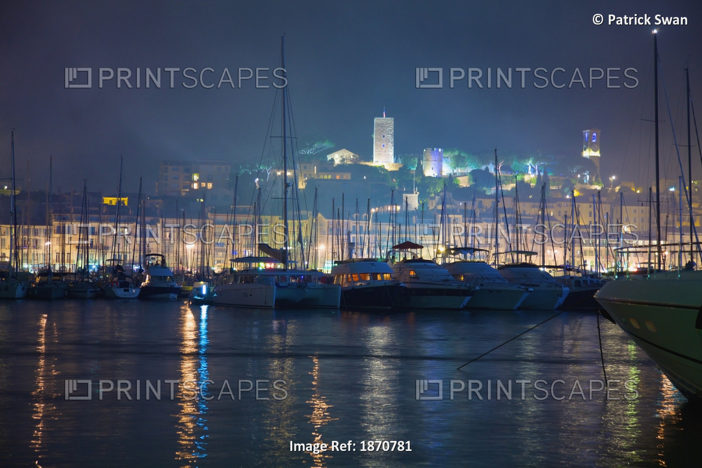 Cannes, Provence, France; Buildings Illuminated On Shore And The Harbor At Night