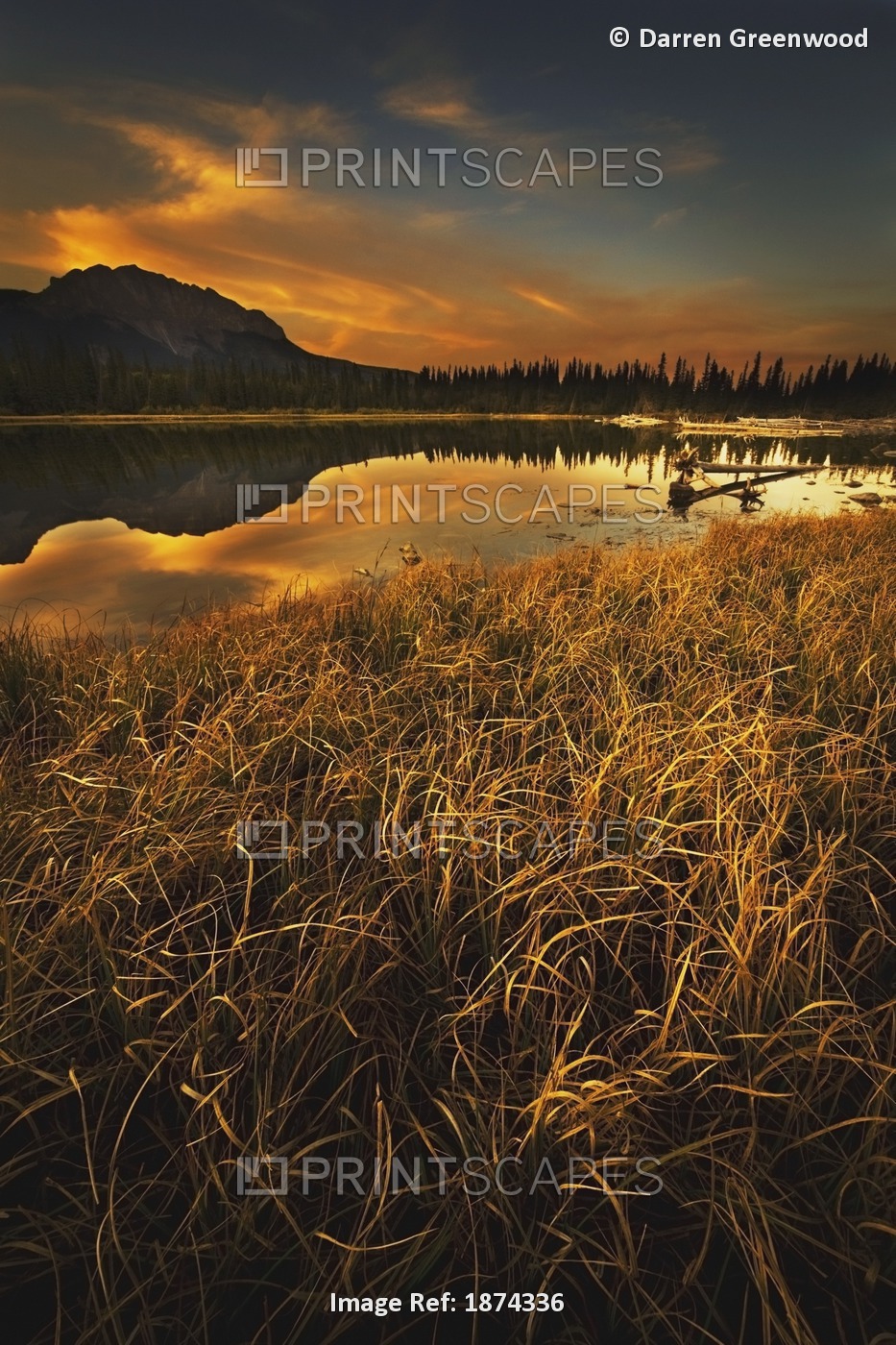 Alberta, Canada; Sunset Over A Lake And Mountains