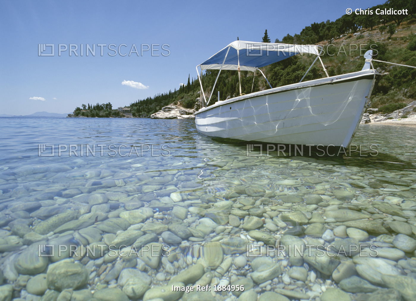 Boat Moored In Clear Water With Pebbles
