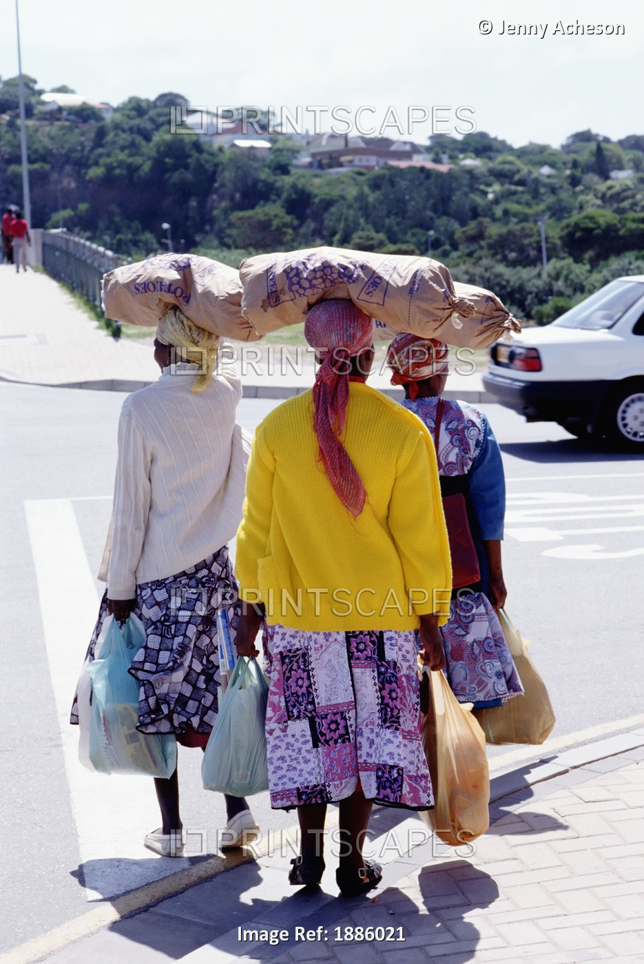 Woman With Sacks On Their Heads Crossing The Street Carrying Shopping