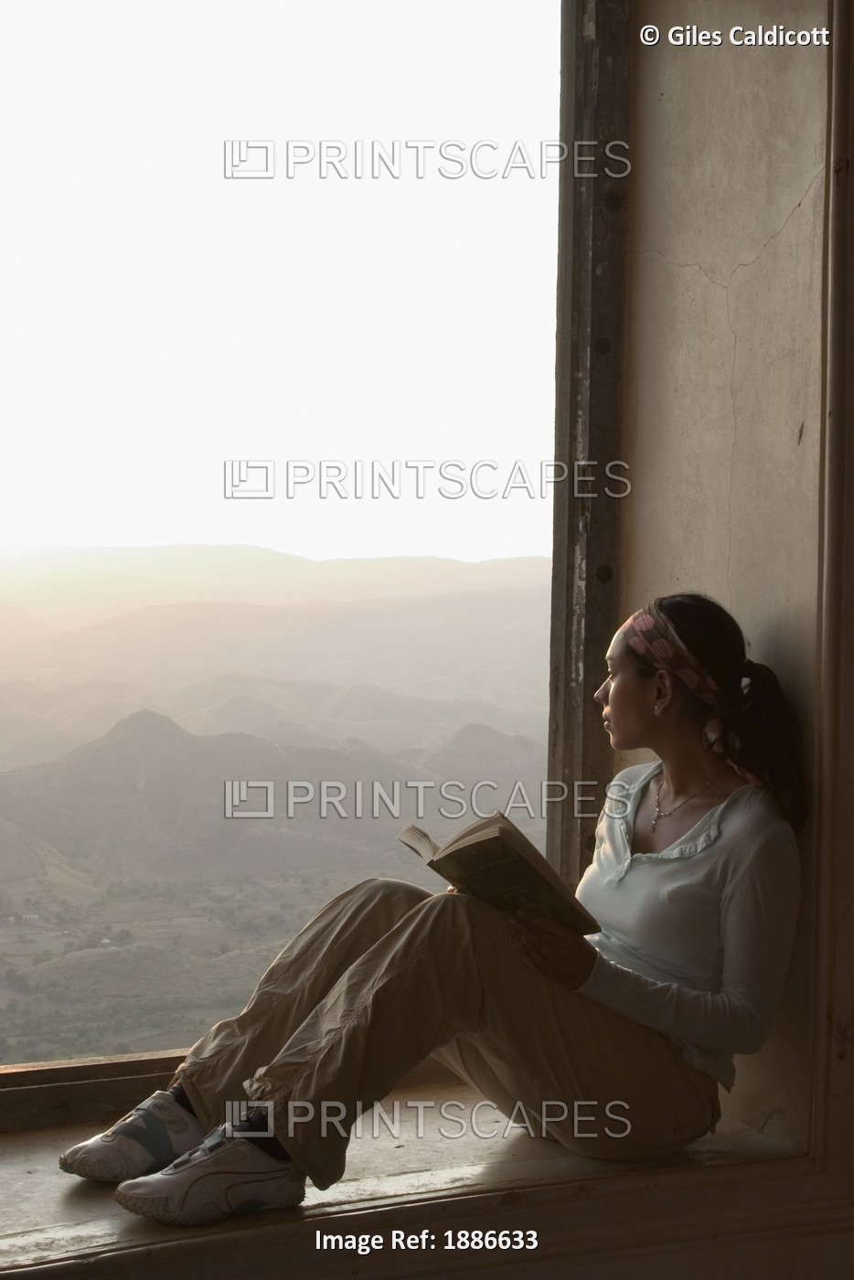 Female Traveller Reading In Window