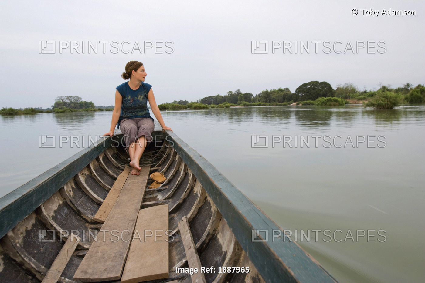 Young Woman Traveller On Boat Trip Amongst The 4000 Islands Of Si Phan Don.
