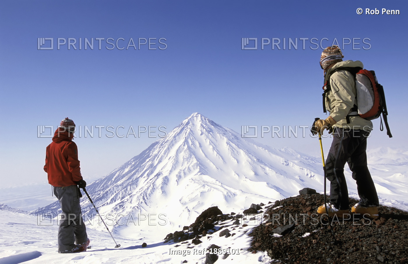 Two Skiers Admiring Snowy Peak