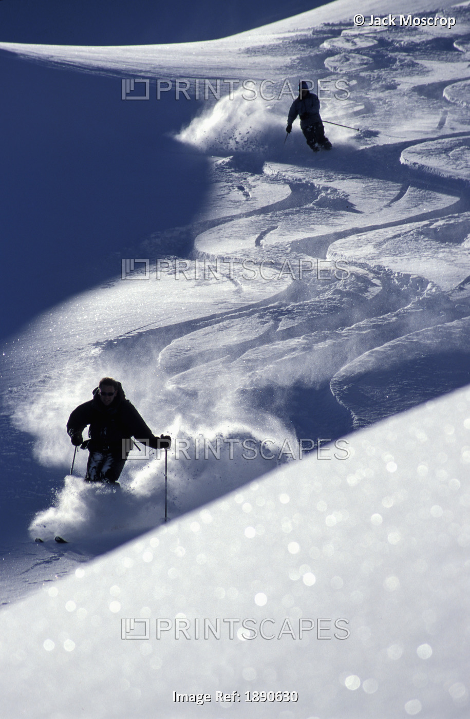 Silhouettes Of Two Skiers On Slope