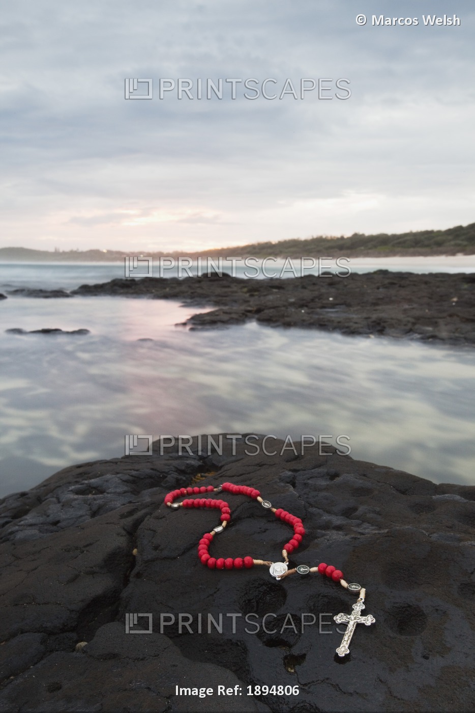 A Cross And Rosary Beads Laying On A Rock At Flat Rock; Ballina, New South ...