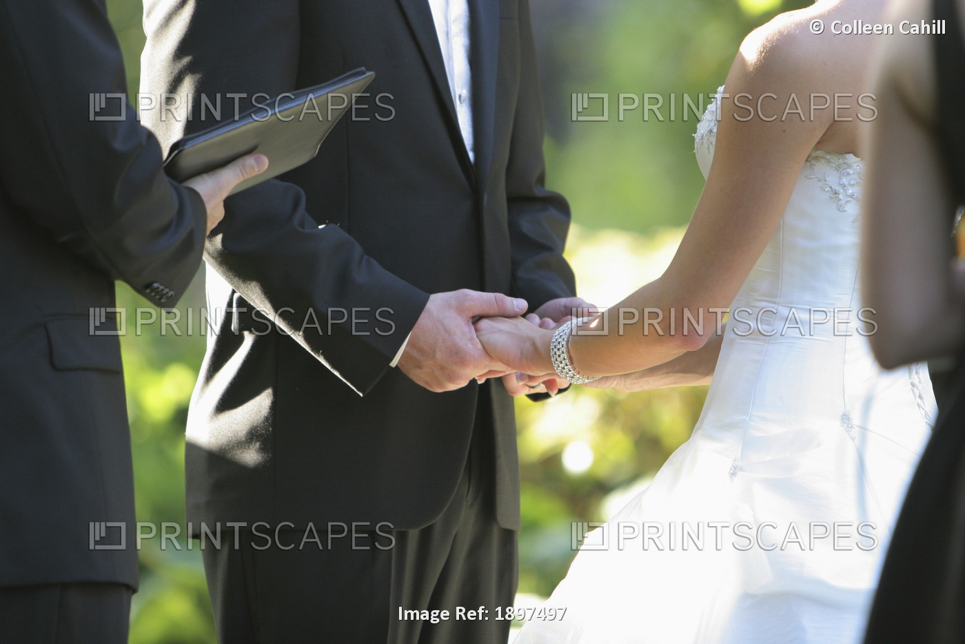 A Bride And Groom Holding Hands During Their Ceremony; Troutdale, Oregon, ...