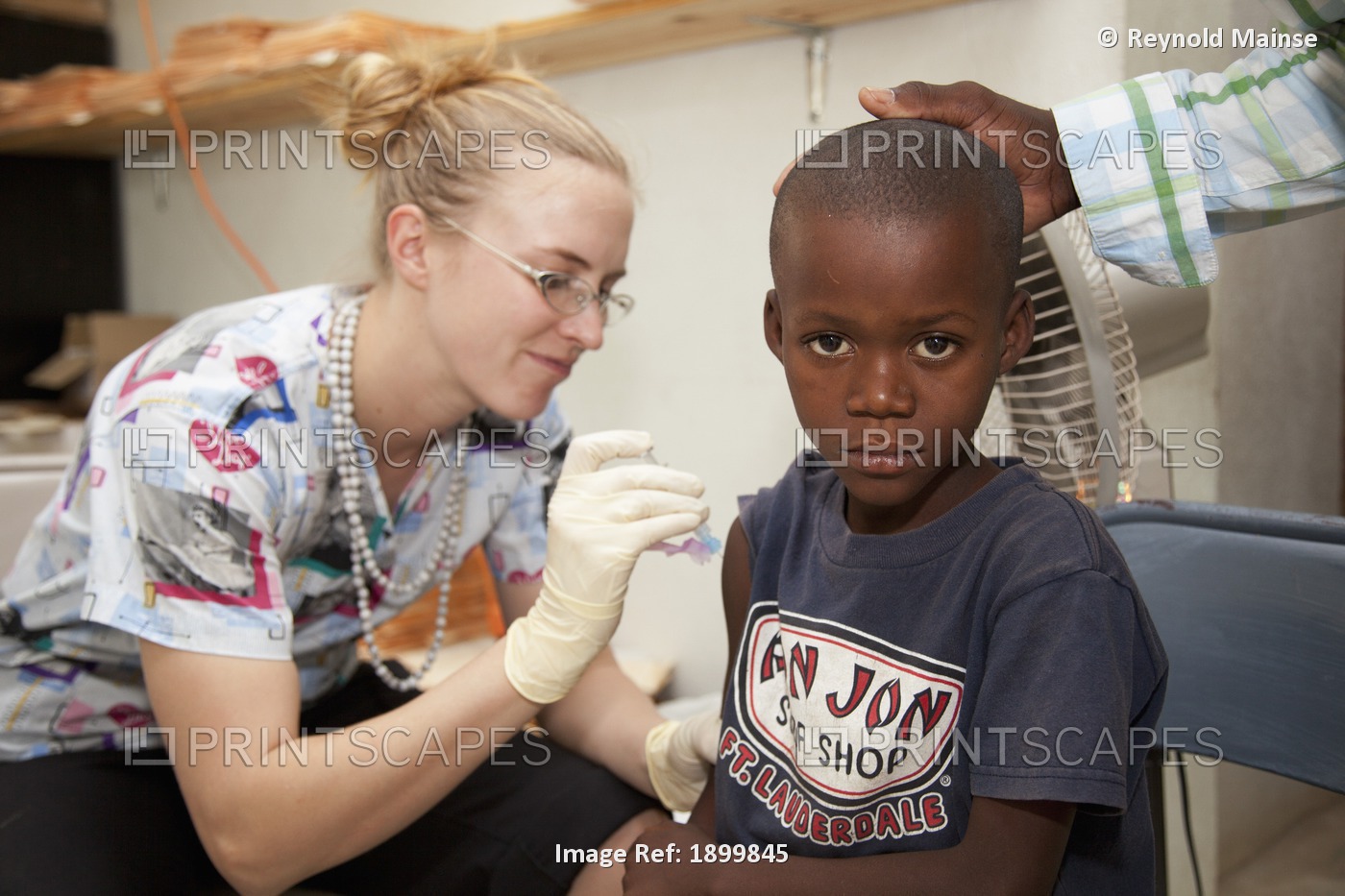 A Nurse Gives A Vaccination To A Boy; Grand Saline, Haiti