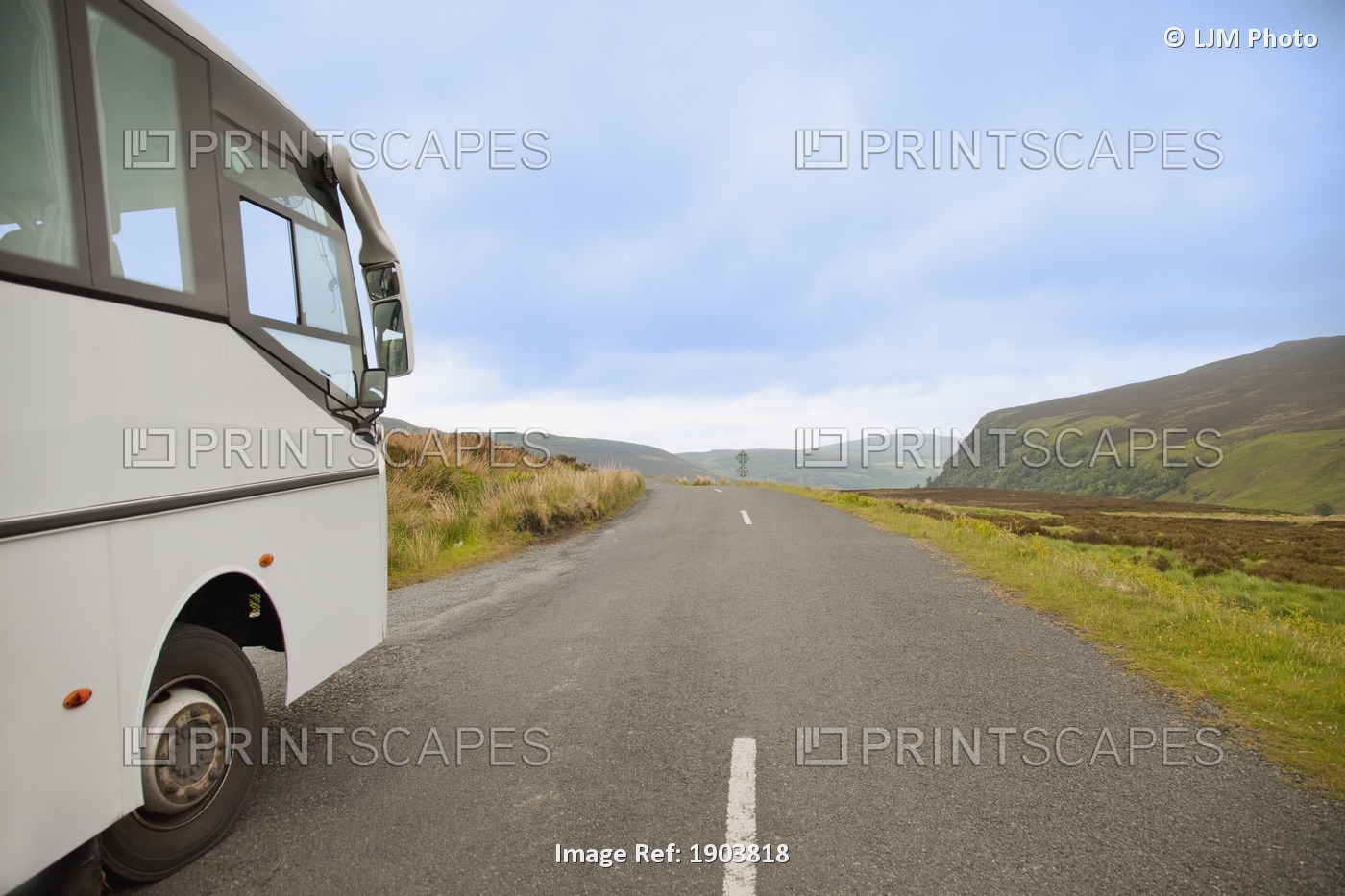 A Bus Traveling Down A Road; County Wicklow, Ireland