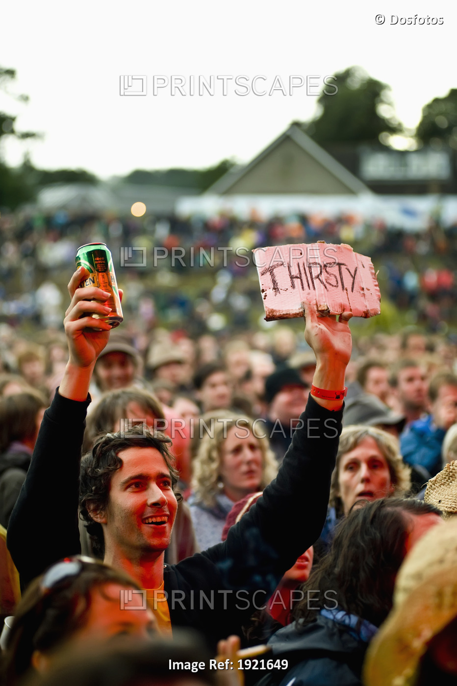Fan with beer at Green Man Festival, Glanusk Park, Brecon Beacons, Wales, UK