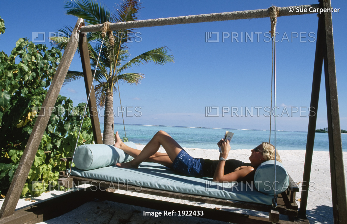 Girl Relaxing On Swing Chair By Sea Â Â Â 