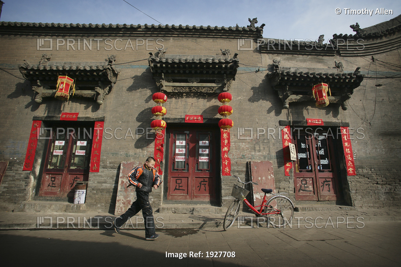 A Local Boy Running Beside A Bicycle And Traditional Chinese House In Pingyao, ...