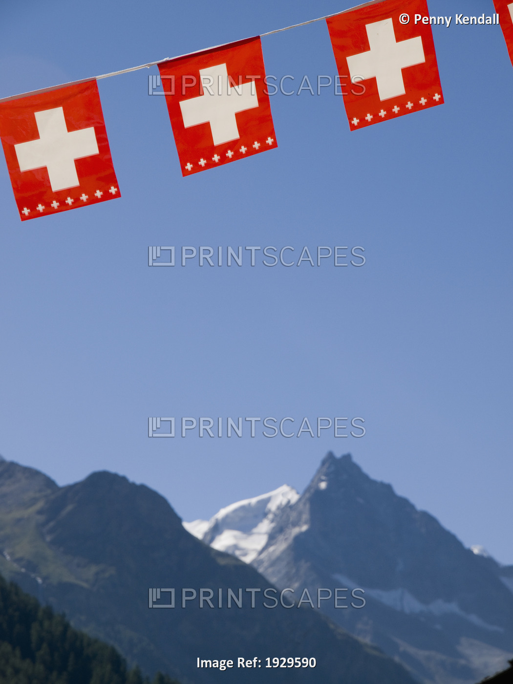Swiss national flag hangs above the Besso mountain. Zinal, Val d'Anniviers, ...