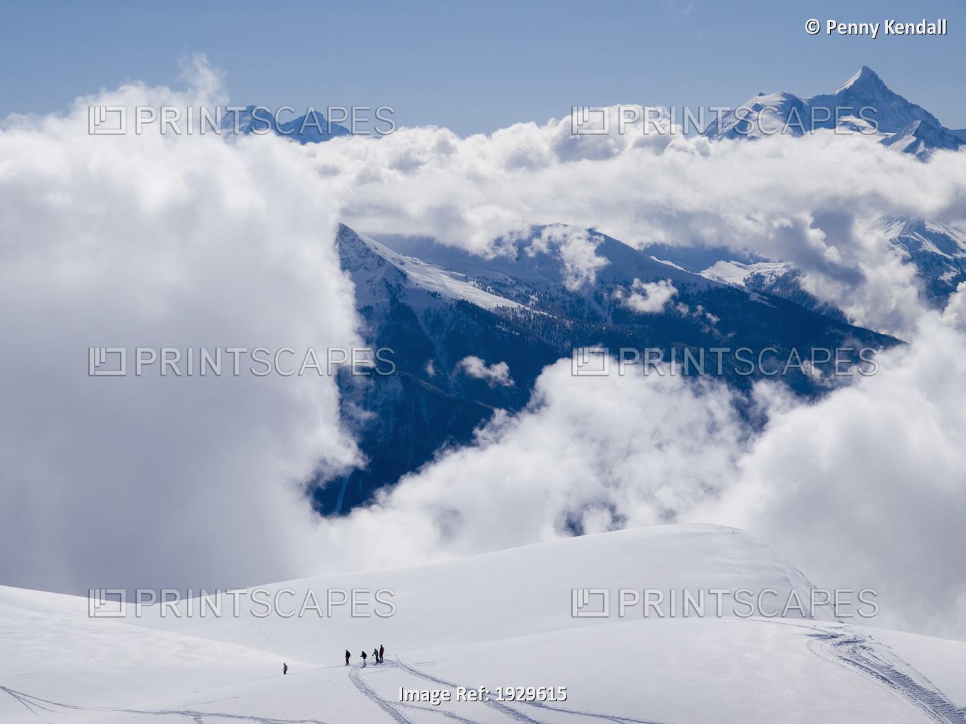 Group of skiers look down onto clouds in the Rhone Valley. Winter in Crans ...