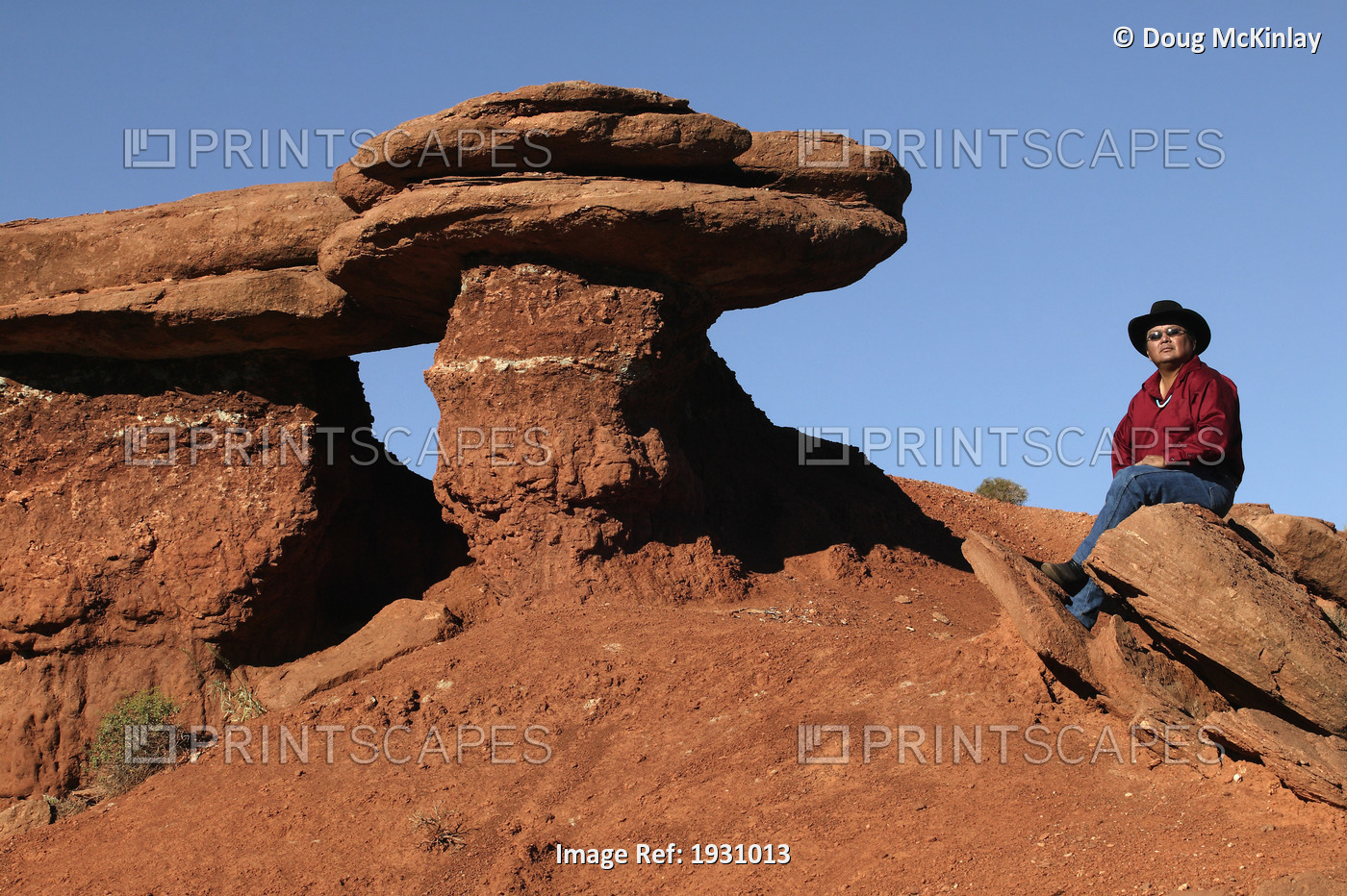 Larry Holiday, Navajo guide, sitting near a rock formation in Monument Valley ...
