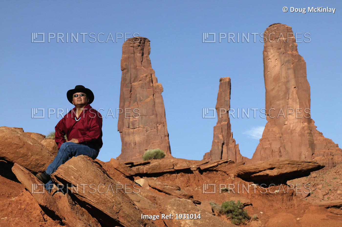 Larry Holiday, Navajo guide sitting with the Three Sisters formation in ...