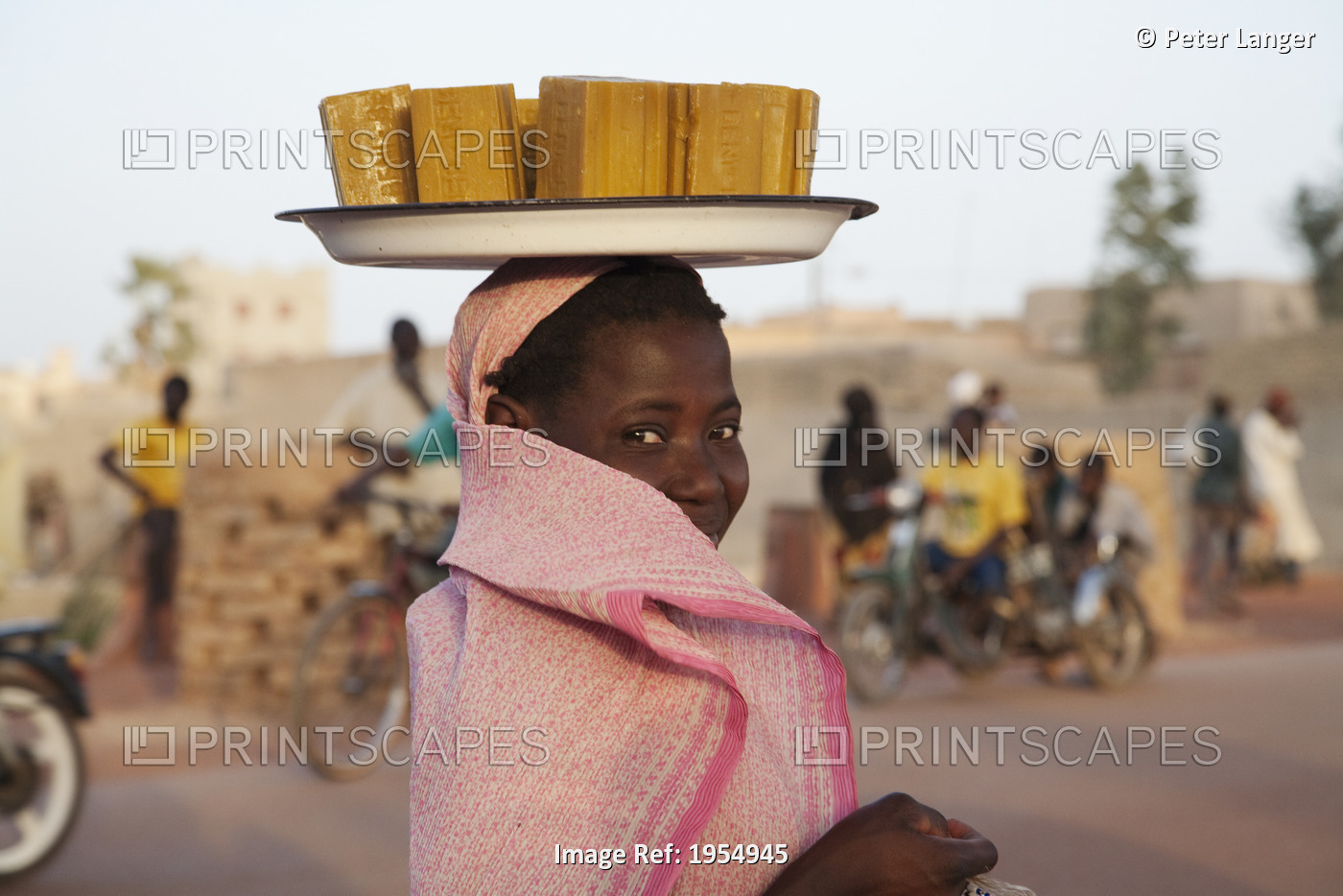 Woman carrying soap bars of her head in Mopti, Mali