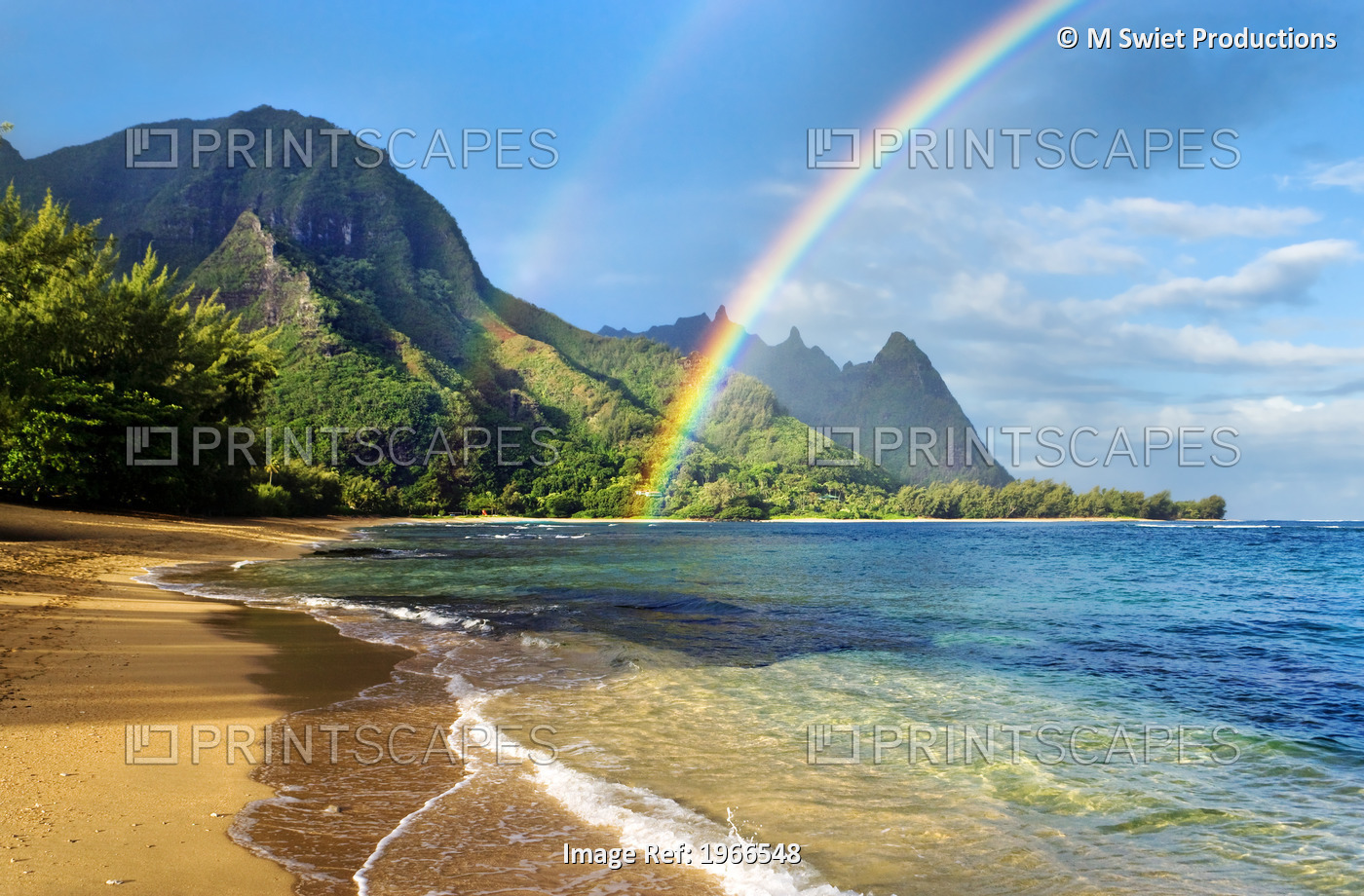 A double rainbow over the coastline of a Hawaiian island with mountains and ...