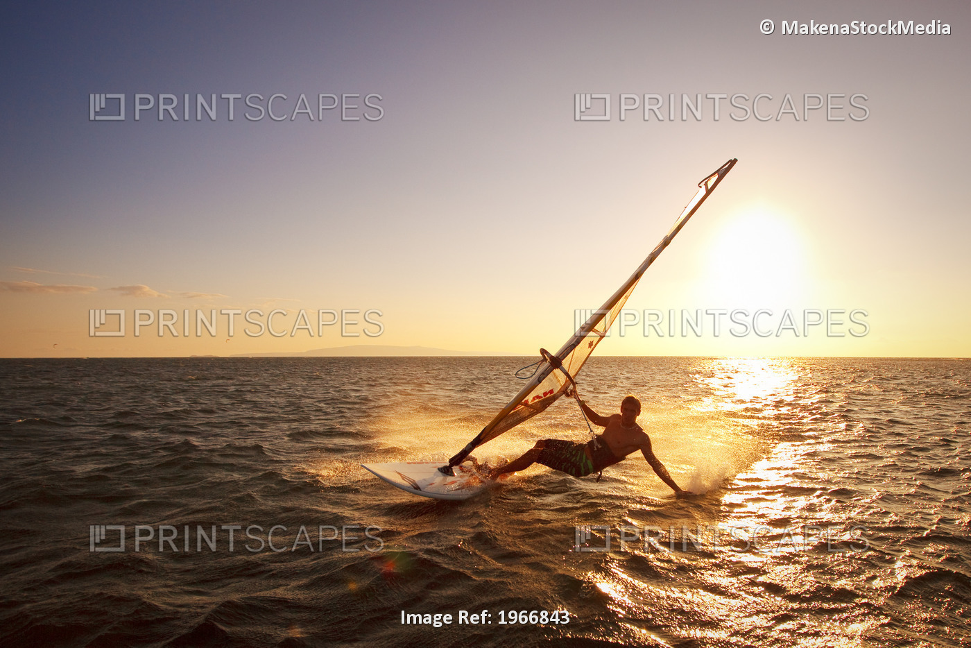 Hawaii, Maui, Kihei, Windsurfer Sailing Off The Coast Of South Maui At Sunset.