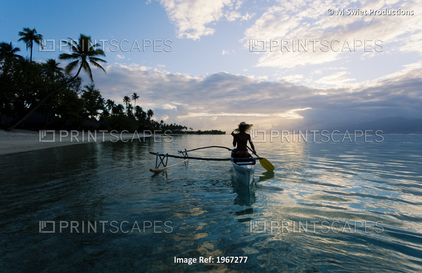 French Polynesia, Moorea, Woman Paddling In Outrigger Canoe Along Shoreline.