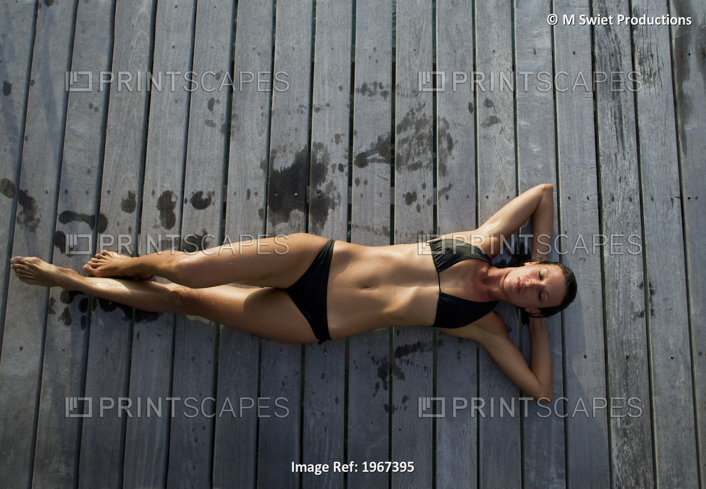 Woman Lounging On Resort Pier.
