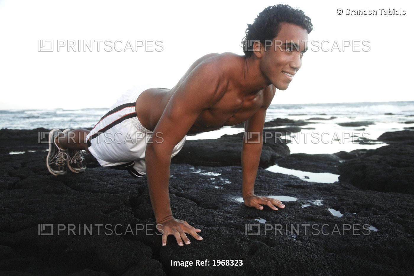 Hawaii, Oahu, Athletic Male Doing Push Ups On The Beach.