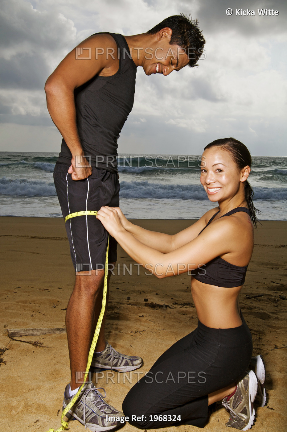 Hawaii, Kauai, Kealia Beach, Young Fit Couple Doing Body Measurements.