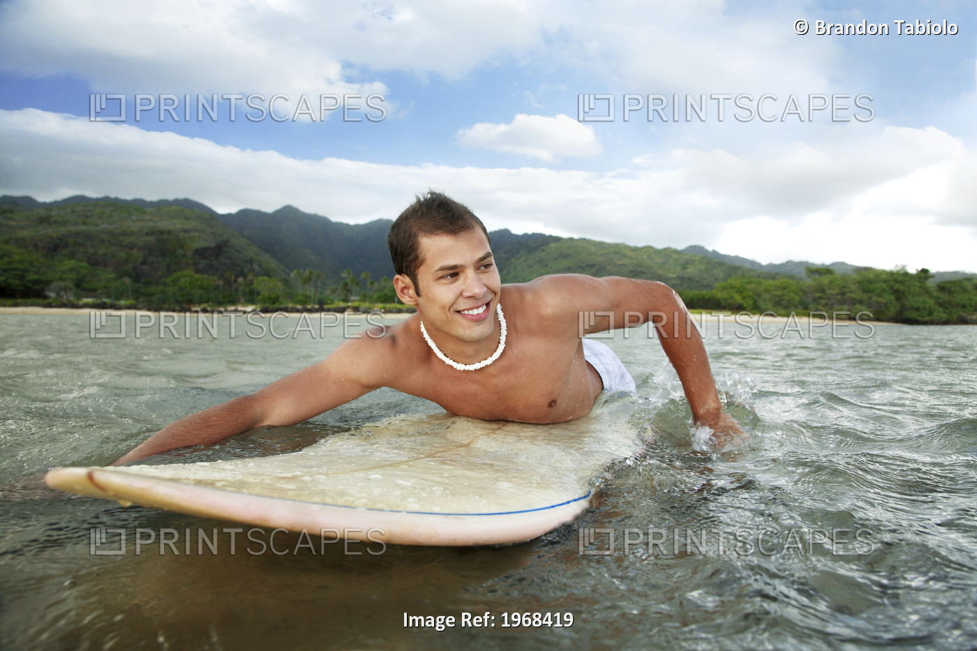 Hawaii, Oahu, Aina Haina, Young Man Paddling On His Surfboard In The Water.