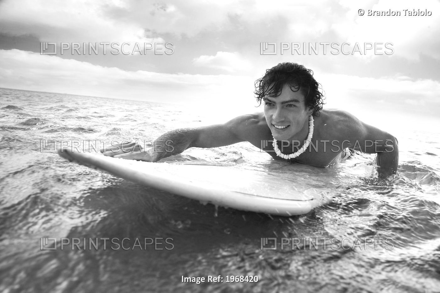 Hawaii, Oahu, Young Man Paddling On His Surfboard In The Water.