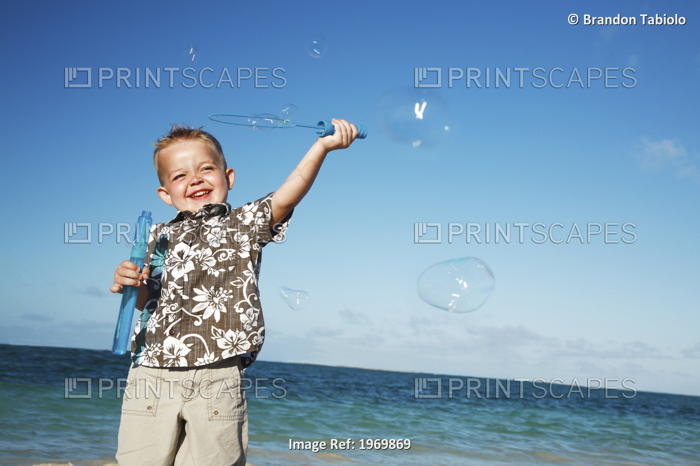 Hawaii, Oahu, Adorable Little Boy With An Aloha Shirt Playing With Bubbles.